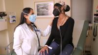 Doctor meets with patient in exam room